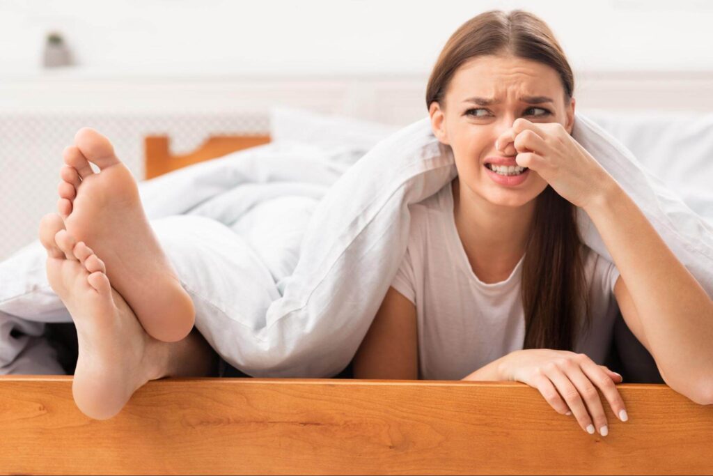 woman thinking how to stop sweaty feet