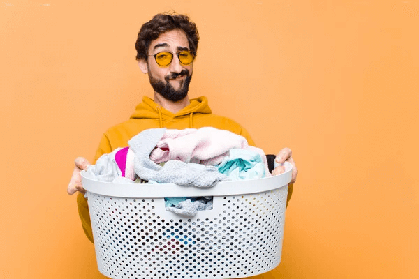 man wondering how to smell good all day by cleaning clothes