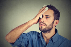 man wondering why his head sweats