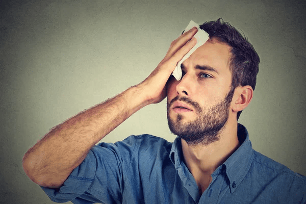 man wondering why his head sweats